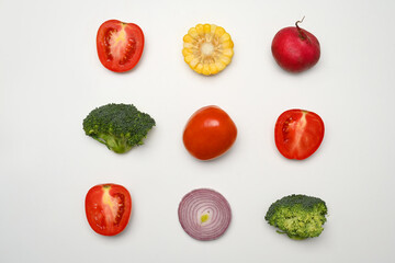 Sliced different fresh vegetables on white background. Healthy food, vegetarian and nutrition concept.