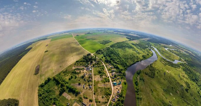 tiny planet in sky with clouds overlooking small village with river. Transformation of spherical 360 panorama in abstract aerial view.