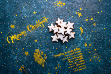 Christmas gingerbread cookies with icing biscuits stars over seasonal holiday background