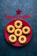 Traditional Christmas Linzer cookies Austrian or German biscuits with shortcrust pastry and jam filling seasonal holiday background