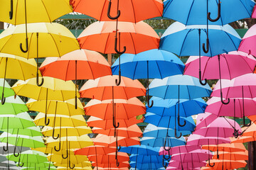 Bottom view of colorful canopy of umbrellas in a park