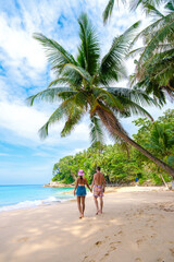 Phuket Thailand, a couple of men and woman walking at the beach of Surin, Surin Beach Phuket