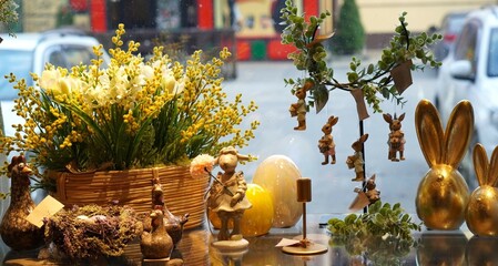  decor for the Easter interior in the form of figures of golden rabbits on a glass table with a...