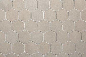 Closeup seamless white and cream hexagonal wall and floor porcelain tiles