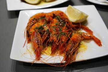 Close up Receta de Langostinos a la plancha, Grilled langoustines shrimp with olive oil -Classic traditional Spanish Tapas