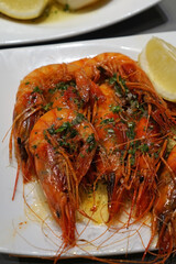 Close up Receta de Langostinos a la plancha, Grilled langoustines shrimp with olive oil -Classic traditional Spanish Tapas