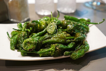 Blistered Padron peppers (Pimientos de Padrón), small green pepper in Canola and olive oil-...