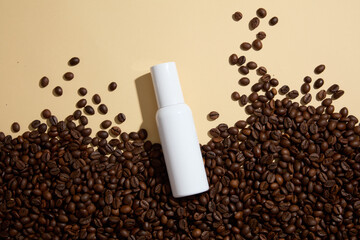 Blank background for advertising cosmetic product with coffee ingredient. Coffee beans decorated with white cosmetic bottle without label for design packaging. Top view
