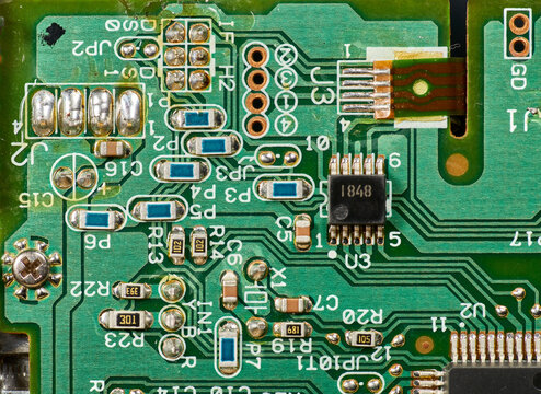 Detail of old electronic components of a motherboard with its chips, capacitors and solders