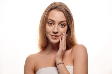Naklejka premium Beauty portrait of a young blonde girl on an isolated white background. Skin care