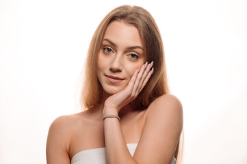 Naklejka premium Beauty portrait of a young blonde girl on an isolated white background. Skin care