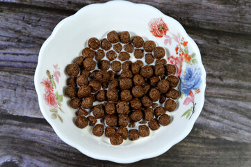 Milk with Breakfast Chocolate flavored balls cereal, as a snack prepared with milk for children and...