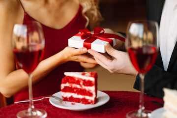 Love, romance, valentine's day. A couple in love in a cafe exchanges gifts and spends time...