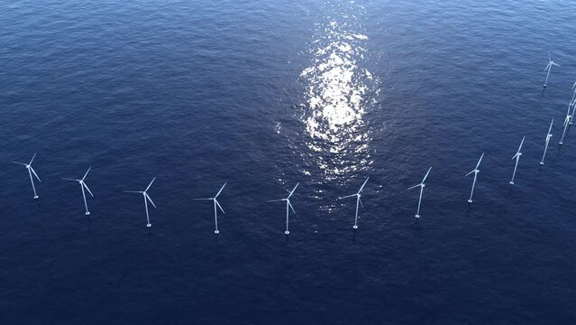 Wind turbines in the ocean on a bright sunny day. 3D animation