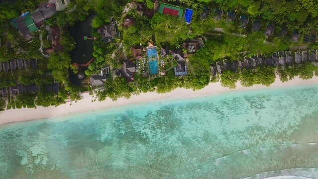 Aerial drone view of travel destination exotic beach resort in the Seychelles Islands. View of the tropical turquoise ocean. Green lush vegetation covering the island. Silhouette Island, Indian Ocean.