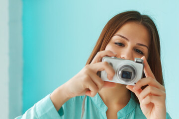 Portrait of a beautiful cute teen girl with digital photo camera
