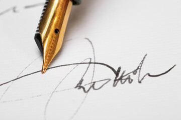 Sheet of paper with fountain pen and signature, closeup
