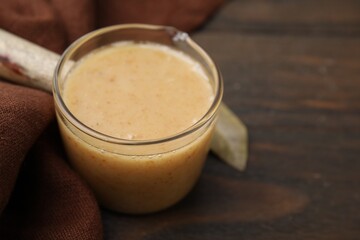 Delicious turkey gravy on wooden table, closeup. Space for text