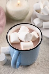 Fototapeta na wymiar Cup of aromatic hot chocolate with marshmallows served on table, closeup