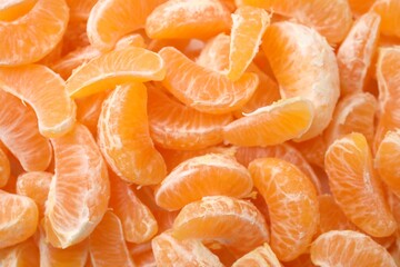 Segments of tasty tangerines as background, top view