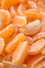 Segments of tasty tangerines as background, closeup