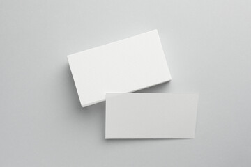 Blank business cards on light grey background, top view. Mockup for design