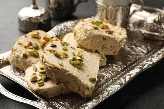 Tasty pistachio halva on grey table, closeup