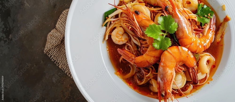 Poster Fried noodles with Shrimp and Squid in thick gravy Rad Na Taley on white plate Top view. with copy space image. Place for adding text or design