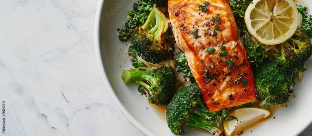 Aufkleber close up of broiled salmon chunks with steamed broccoli florets in white bowl on white wood table landscape view. with copy space image. Place for adding text or design