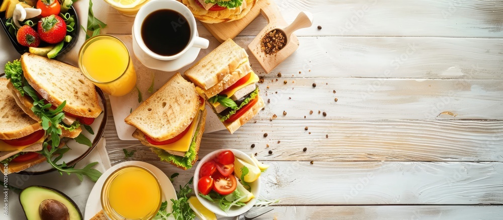 Poster Breakfast with club sandwiches with fresh tomatoes lettuce and cucumbers salmon trout coffee and freshly squeezed juice on white stone concrete table top view copy space. with copy space image