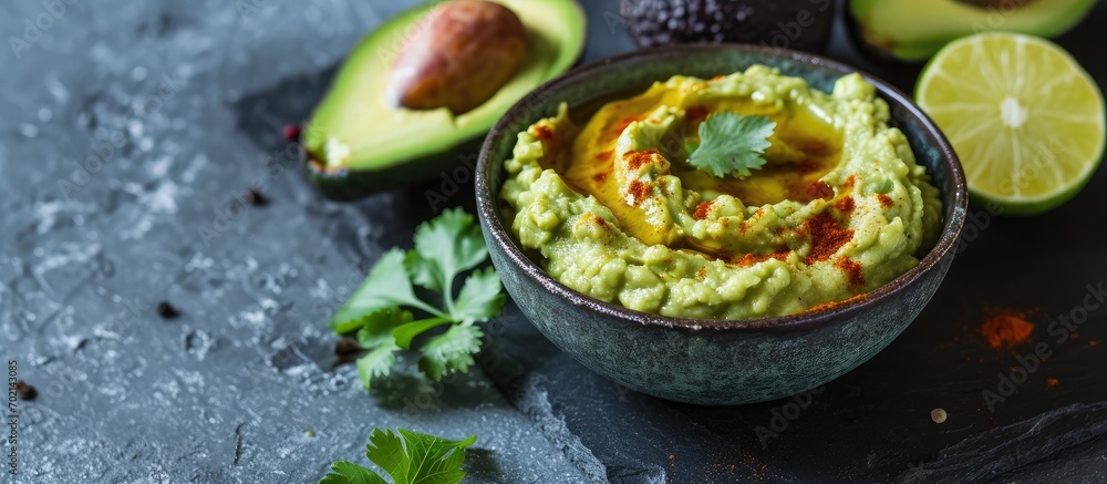 Poster avocado hummus in a gray bowl healthy eating vegetarian food. with copy space image. place for addin