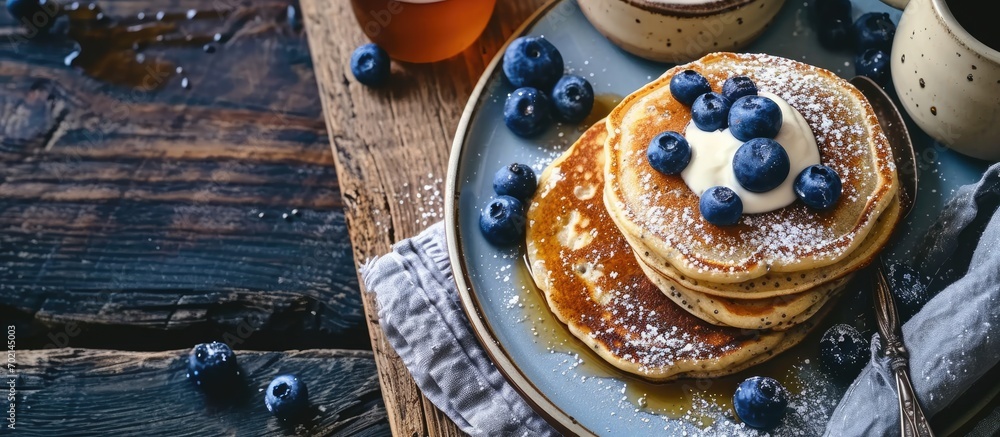 Poster Chia seed pancakes with yogurt and blueberries on plate closeup view. with copy space image. Place for adding text or design