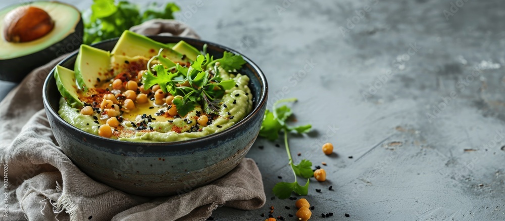 Poster avocado hummus in a gray bowl healthy eating vegetarian food. with copy space image. place for addin