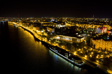 Astrakhan, Russia. Embankment of the river Volga. Cruise ship at the pier. Night city lights....