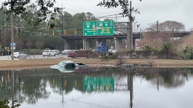 Truck crashed into pond right off a busy highway.