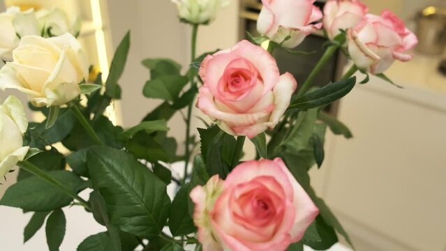 Bouquet of beautiful pink roses in a vase close up. Roses in the interior of the apartment