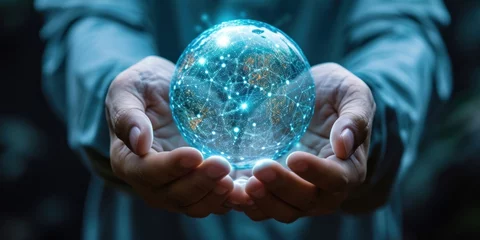 Fotobehang Hands of man holding white and blue hologram sphere of big data network © Attasit