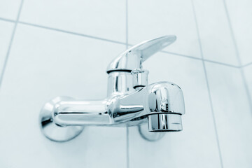 Modern bathroom with clean and sleek design, metal fixtures, and tiled flooring.