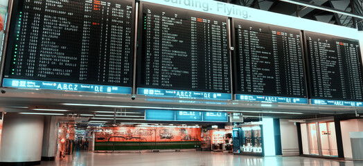 airport display with flight schedules and times