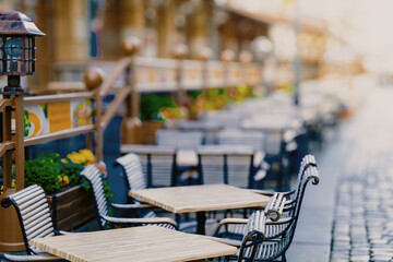 chairs and tables of a street restaurant in an empty city