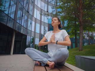 De-stress, unwind idea. peaceful female freelance employee practicing yoga exercises while sitting...