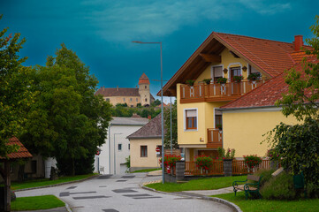Fototapeta na wymiar Austrian village with old castle before the rain. Bernstein view. 