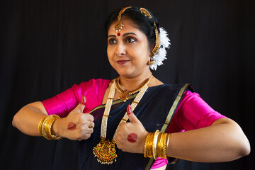 Woman Indian classical dancer demonstrate Bharatanatyam dance mudra in close up