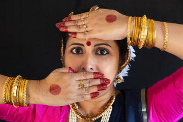 Beautiful Indian woman classical dancer in traditional costume and jewelry in close up view
