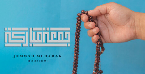 Jummah Mubarak blessed happy Friday Arabic calligraphy, Selective focus image hand of Muslim woman...