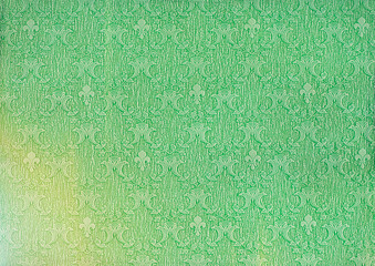 Background of paper old emerald green wallpaper with a vintage pattern.