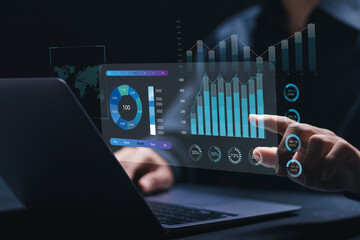 Businessman working with data management system on computer to make report with KPI and metrics...
