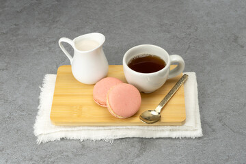 Coffee and macarons on tray on table. Copyspace for your text