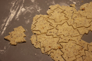 Close-up of raw dough for salty cookies with walnuts on a gray table