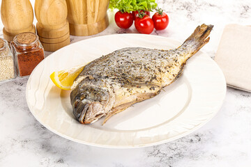 Baked Dorado fish served lemon
